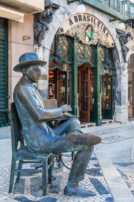 A statue of poet Fernando Pessoa sits in front of Café A Brasileira in Lisbon's Chiado district.