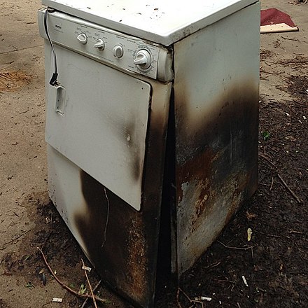 A clothes dryer that has been damaged by fire
