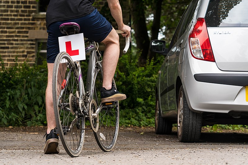File:Cycling on the roads with a learner l plate on bike.jpg