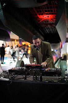 DJ Yoda performing in 2014 DJ Yoda at Royal Air Force Museum Hendon (14172431056).jpg