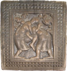 A wood carving at Embekka Devalaya, depicting angam fighters in one of the main locks, 14th century AD Embekka Wrestlers.png