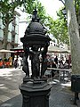 Català: Font Wallace. La Rambla davant del passatge de la Banca (Barcelona). Escultor: Charles-Auguste Lebourg, signada. Material: ferro colat pintat. Original de 1872. Instal·lades a Barcelona per primer cop el 1888. This is a photo of public art indexed in the cataloge Art Públic of Barcelona (Spain) under the code number 1870-1 (prefixed with territorial id: 08019/1870-1) Object location 41° 22′ 37.6″ N, 2° 10′ 36.34″ E  View all coordinates using: OpenStreetMap