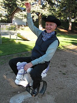 Gagliano pictured in a cowboy outfit riding a horse at a children's playground