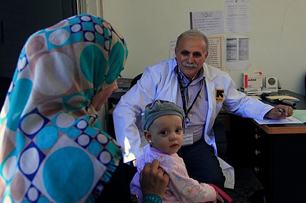 An IRC doctor conducting a check-up on a young Syrian refugee, Ramtha, Jordan, 28 August 2013