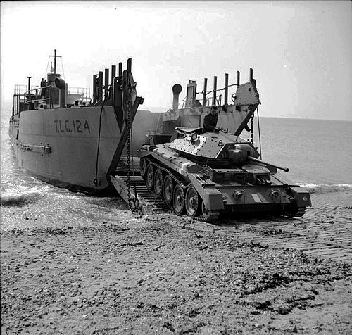 A Crusader tank landing on a beach from a Tank Landing Craft in a 1942 test.