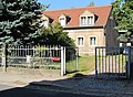 Residential house with back building, in open development