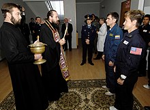Astronauts receiving blessing from a Russian Orthodox priest