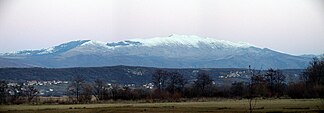 Snow-covered Kamešnica with a peak Konj