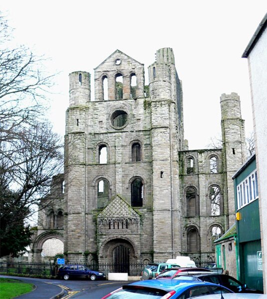 The north transept of the west crossing, showing the north doorjamb and full gable flanked with massive columnar towers.