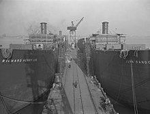 The Union Sulphur-operated John Randolph (at right) under construction Liberty ship construction 14 fitting out.jpg