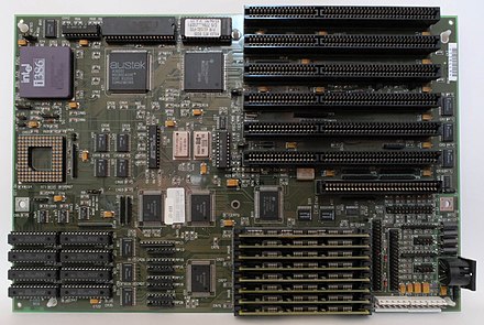 Example of a motherboard with an i386 microprocessor (33 MHz), 64 KiB cache (25 ns; 8 chips in the bottom left corner), 2 MiB DRAM (70 ns; 8 SIMMs to the right of the cache), and a cache controller (Austek A38202; to the right of the processor)