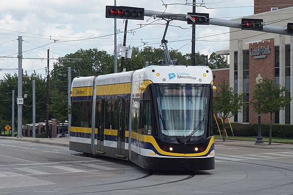 A streetcar turning from Zang Blvd. onto Colorado Blvd., outbound on the 2015-opened section of the line