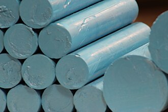 A stack of Turquoise Blue "Pigment Sticks" in the factory of R&F Handmade Paints in Kingston NY ready to be wrapped. Pigment Sticks .jpg