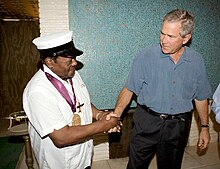 Domino (age 78) with the National Medal of Arts replaced by President George W. Bush on August 29, 2006, after the original medal, awarded to him by President Bill Clinton, was lost in the floodwaters of Hurricane Katrina.