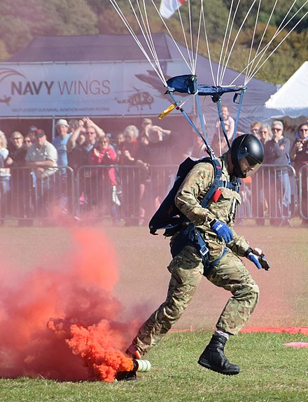 Red smoke carried by a parachutist of the UK Lightning Bolts Army Parachute Display Team