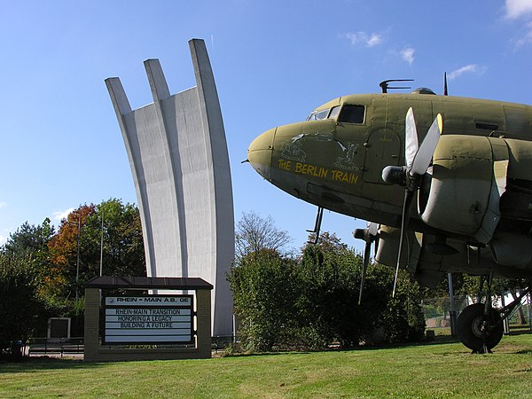 Memorial with a Douglas C-47 Skytrain (USAF) nearby.