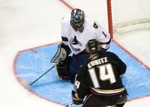 Luongo with Chris Kunitz of the Anaheim Ducks in a pre-season game at the lip of his crease in September 2006