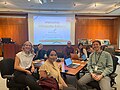 Seven smiling Society of Physics Students interns with a Wikipedia editor PowerPoint backdrop, at the American Institute of Physics.