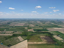 An aerial photo over northern Ohio; much of the central United States is covered by relatively flat, arable land. Scipio Township near Republic.jpg