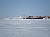 Tug and barges overwintering in Cambridge Bay after the annual sealift