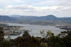 Hobart (on the left) is centred around Sullivans Cove, at which a cruise ship is docking. Tasman Bridge.jpg