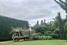 Surrealist Garden, with moving 'tree' branches and outsize tools and gate. The 'trees' wave their branches.jpg