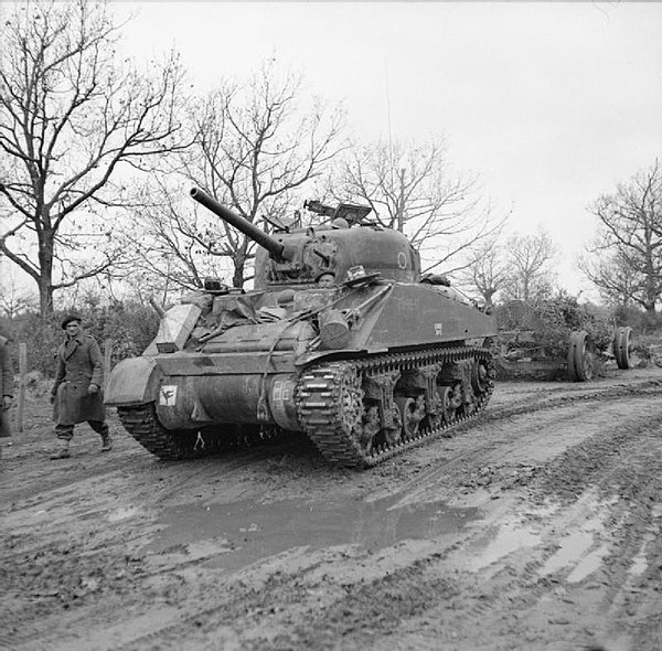 A Sherman tank of the 46th Royal Tank Regiment towing a German 155 mm gun, captured by the 2nd Battalion, North Staffordshire Regiment, 23 January 194