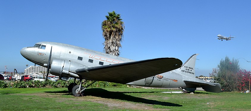 Boeing 247 historic airplane in the flightpath of an American Airlines airplane preparing to land.