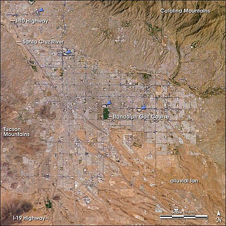 Tucson, as seen from space. The city's four major malls are indicated by blue arrows.