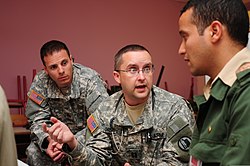 A physician assistant with the Utah State Medical Command, Utah Army National Guard, speaks to an interpreter while working at a humanitarian civic assistance. U.S. Army Capt. Enoch D. Christopherson, center, a physician assistant with the Utah State Medical Command, Utah Army National Guard, speaks to an interpreter while working at a humanitarian civic assistance 120413-A-QD330-109.jpg