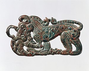 Belt plaque in the shape of a standing wolf, characteristic of nomadic artifacts of southern Ningxia and southeastern Gansu, and related to the Scythian styles of Pazyryk. 4th century BC.[28][25]