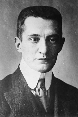 Head and shoulders black-and-white photograph of a clean-shaven Kerensky in his late-thirties/early-forties with dark eyes and hair