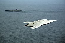 Unmanned X-47B with USS George H.W. Bush (CVN 77) in the background An X-47B Unmanned Combat Air System demonstrator flies near the aircraft carrier USS George H.W. Bush.jpg