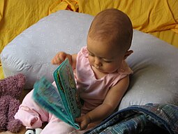 Developmental psychologists would engage a child with a book and then make observations based on how the child interacts with the object. Baby with book.jpg