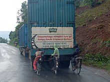 The Kirundi text on the back of the truck warns cyclists not to hold on to it. Bicycles in Burundi.jpg