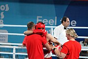 Deutsch: Boxen bei den Olympischen Jugendspielen 2018 Tag 12, 18. Oktober 2018 - Kampf um Bronze im Leichten Weltergewicht Jungen – Hassan Azim (Großbritannien, rot) schlägt Mohammed Boulaouja (Marokko, blau) RSC; Ringrichter ist Wulfren Olivares Peréz (Kolumbien). English: Boxing at the 2018 Summer Youth Olympics on 18 October 2018 – Bronze Medail Match Light Welterweight Boys - Hassan Azim (Great Britain, red) beats Mohammed Boulaouja (Morocco, blue) RSC; Referee is Wulfren Olivares Peréz (Columbia). Español: Boxeo en los Juegos Olímpicos Juveniles de Verano de 2018 en 18 de octubre de 2018 - Medalla de bronce de los hombres ligeros de peso welter: Hassan Azim (Gran Bretaña, rojo) vence a Mohammed Boulaouja (Marruecos, azul) RSC; El árbitro es Wulfren Olivares Peréz (Colombia).