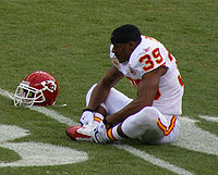 Carr stretching before a game in January 2010 Brandon Carr.JPG