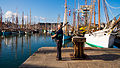 A man plays bagpipe next to Capstan, during the international Celtic-Maritime festival "Festival du chant de marin"