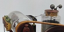 Close-up of metal rake + glass tumbler. Leyden jar is to the right. Close-up of metal rake.jpg