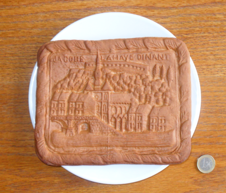 Couques de Dinant are fairly large. Here a smallish one is shown with a 1 euro coin for scale. The design is a view of Dinant. Couque de Dinant with scale.png