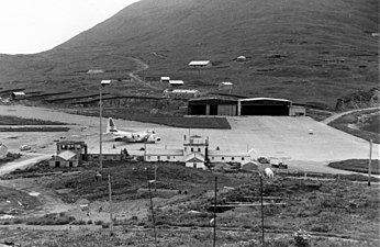 View of Dutch Harbor ramp area with a USCG C-130 Hercules on stand-by for an emergency flight.