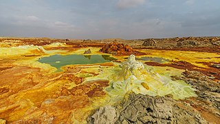 Dallol is a unique, terrestrial hydrothermal system around a cinder cone volcano in the Danakil Depression, northeast of the Erta Ale Range in Ethiopia. It is known for its unearthly colors and mineral patterns, and the very acidic fluids that discharge from its hydrothermal springs.