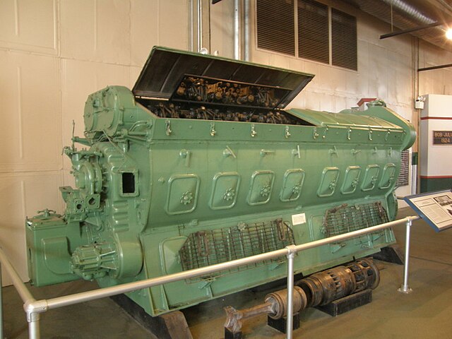 An EMD 16-567B on display at the North Carolina Transportation Museum. Shown in the foreground is an exploded power assembly, with the piston, piston 