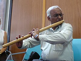 One of our participant, playing flute in the airport whilst waiting for the plane... delayed of course