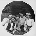 Four men and a woman sitting on grass holding tennis rackets, August 4, 1898 (WASTATE 2515).jpeg