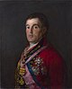 Halvlangt portræt af mand med kort, mørkt hår iført en rød frakke dekoreret med et stort antal medaljer og skær.