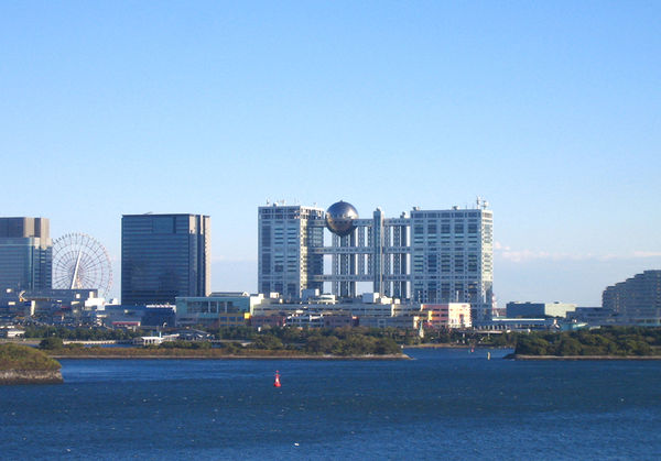 View of Odaiba from the north, with Fuji TV building in the center, Daikanransha Ferris wheel to the left, shopping malls in the front, and Nikko hote