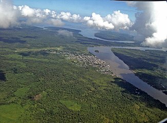 View over the city of Guapi and the River Guapi;  in the background its confluence with the Pacific Ocean