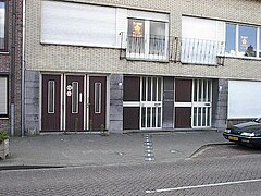 House on Chaamseweg street in Baarle, village that is divided between Belgium and Netherlands. State border is marked by the line of white plates on the sidewalk