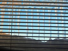Venetian blinds Icicles behind venetian blinds with blue sky.jpg